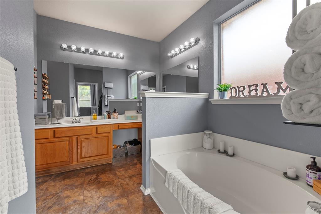 4100 Chisos Rim Trail Fort Worth, TX 76244 - Photo 15 of 30 a bathroom with a tub sink and mirror