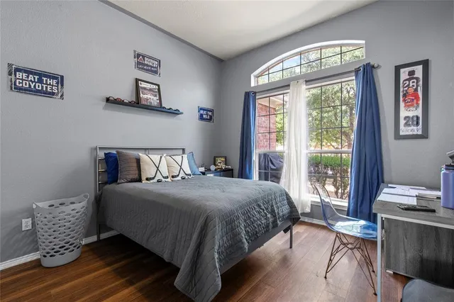 a bedroom with furniture and a large window