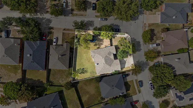 an aerial view of a house with outdoor space