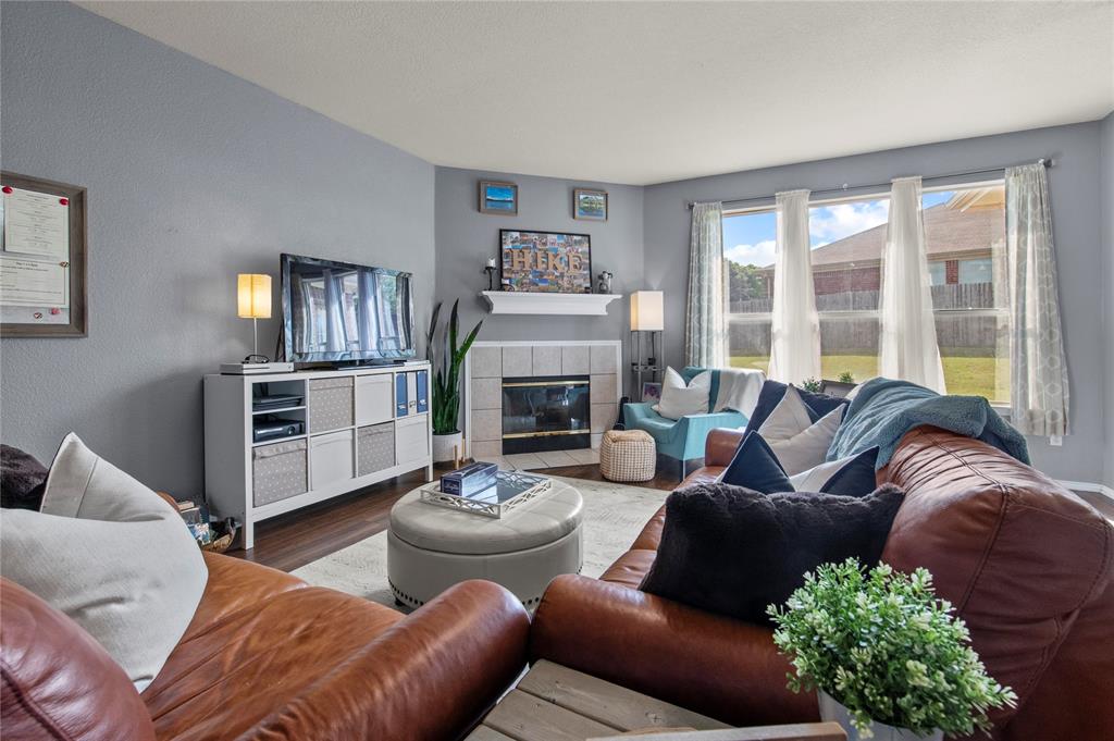 4100 Chisos Rim Trail Fort Worth, TX 76244 - Photo 7 of 30 a living room with furniture fireplace and a large window