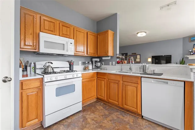a kitchen with a sink stove and cabinets
