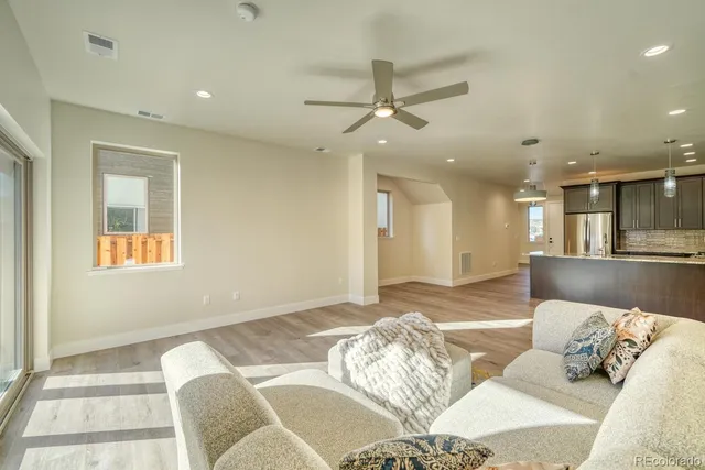 a bedroom with a bed and ceiling fan