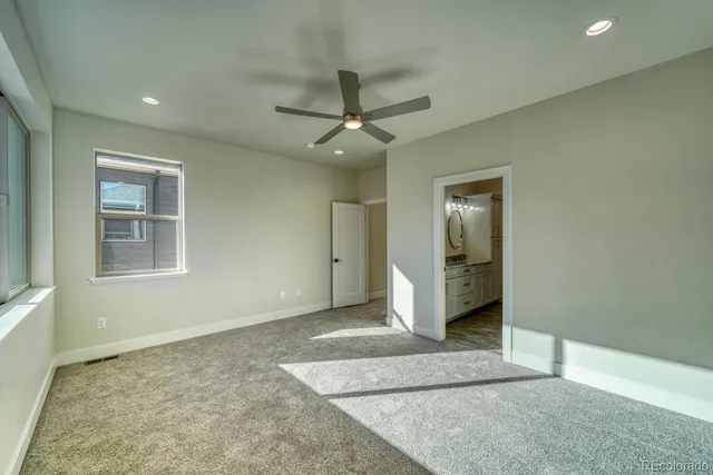 a view of a livingroom with a ceiling fan and window