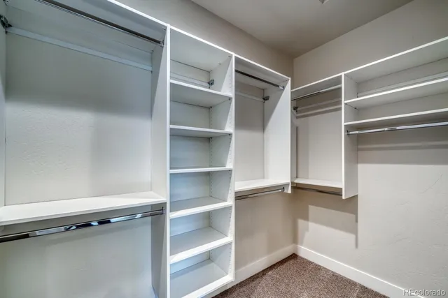a view of walk in closet with empty racks