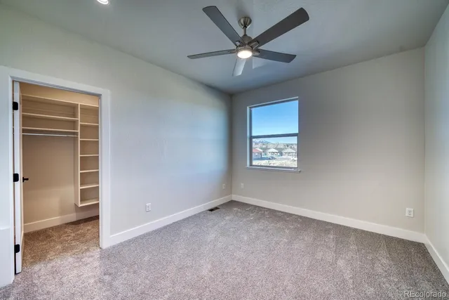 a view of walk in closet with empty racks