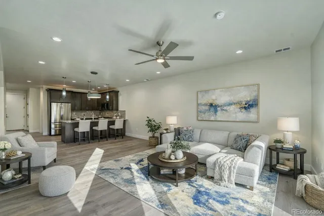 a kitchen with a dining table chairs stainless steel appliances and cabinets