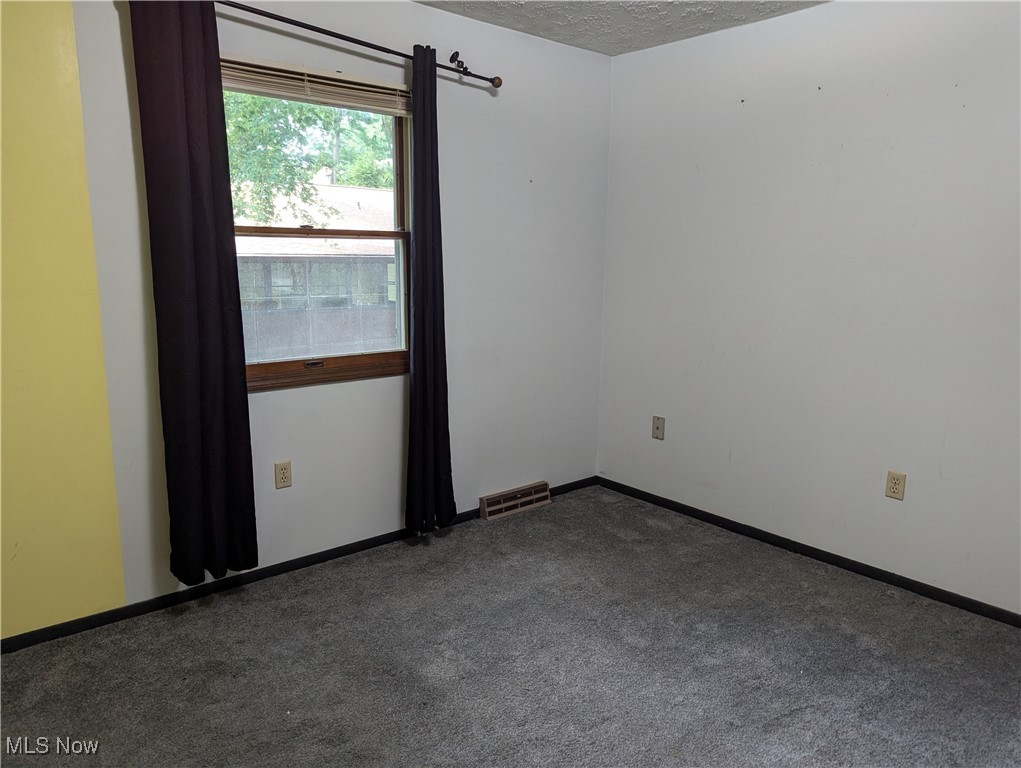 2500 Cleveland Road, Unit 202 Wooster, OH 44691 - Photo 20 of 22 Carpeted spare bedroom with a textured ceiling