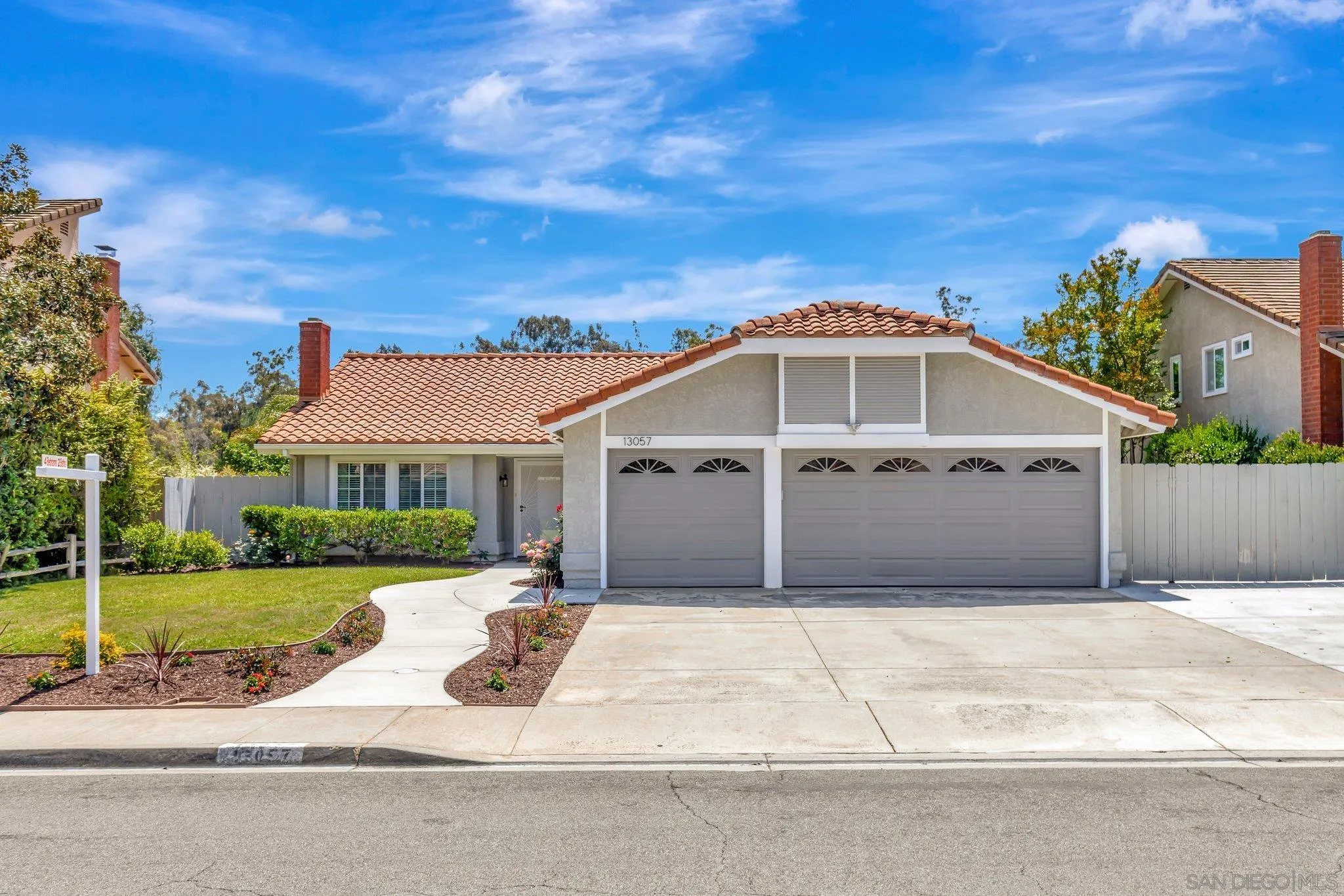 13057 Triumph Drive Poway, CA 92064 - Photo 2 of 31 a front view of a house with a yard and potted plants