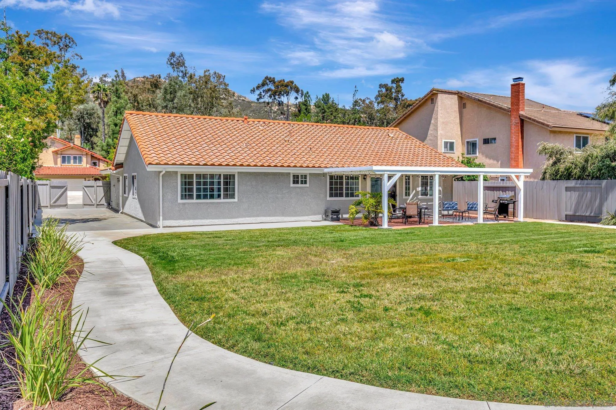 13057 Triumph Drive Poway, CA 92064 - Photo 22 of 31 a front view of a house with a garden and yard