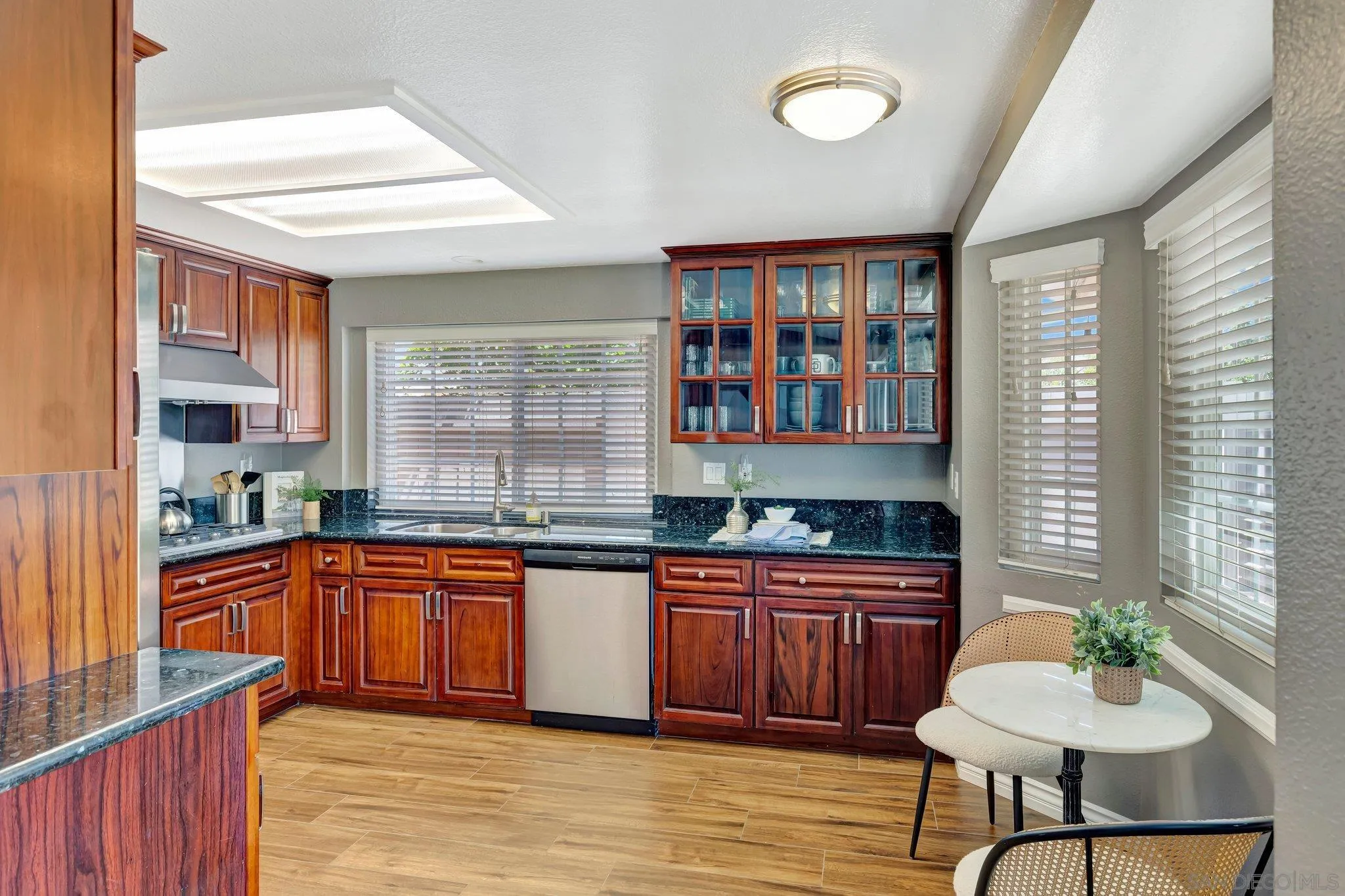 13057 Triumph Drive Poway, CA 92064 - Photo 10 of 31 a kitchen with stainless steel appliances granite countertop wooden cabinets a sink and dishwasher