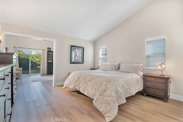 a bedroom with a bed and a large window