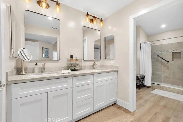 a bathroom with a double vanity sink and a mirror