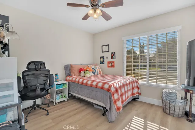 a bedroom with a bed chair and window