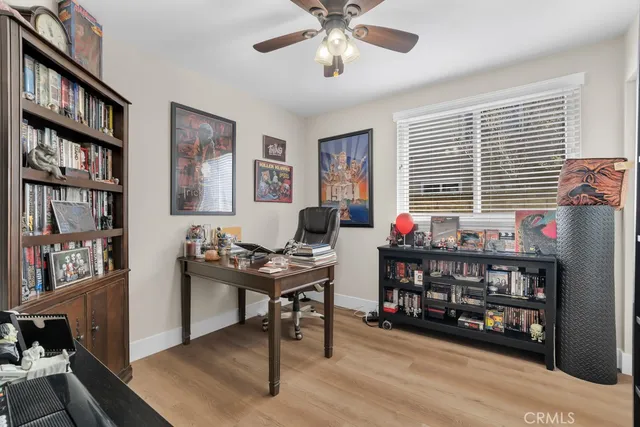 a work room with furniture bookshelf and a window