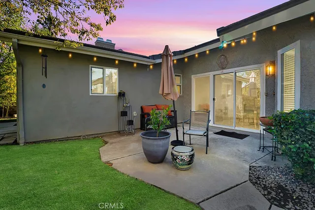 a view of a house with backyard sitting area and garden