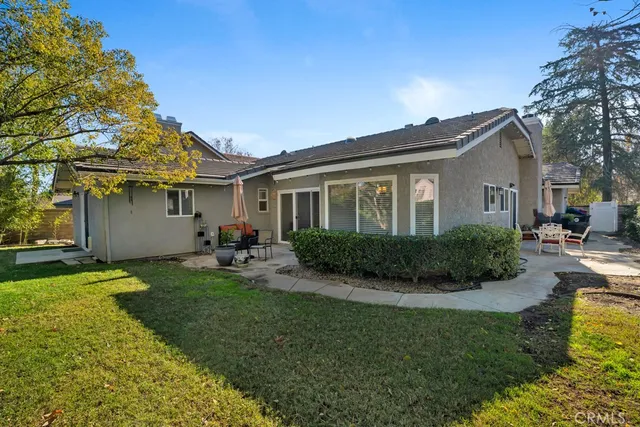 a view of a house with a big yard and potted plants
