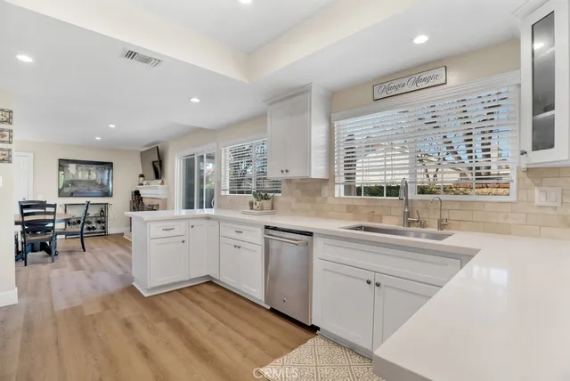 a kitchen with sink cabinets and dining table