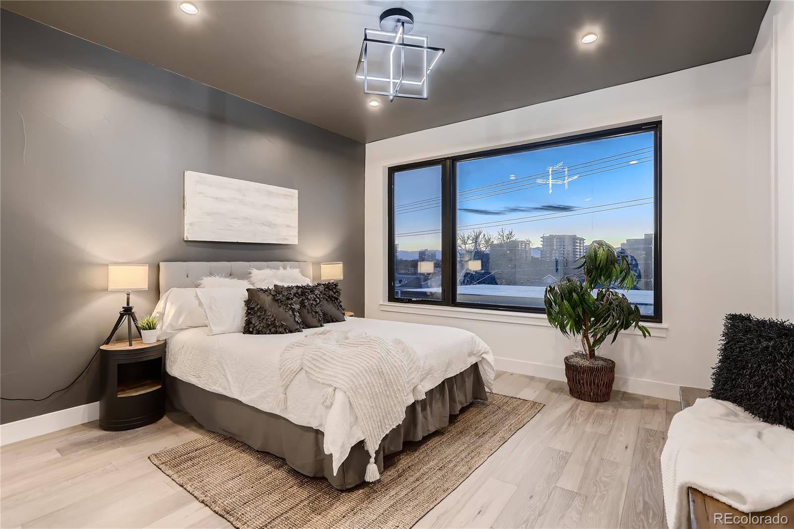 29 Harrison Street Denver, CO 80206 - Photo 12 of 40 a bedroom with a large bed and a chandelier