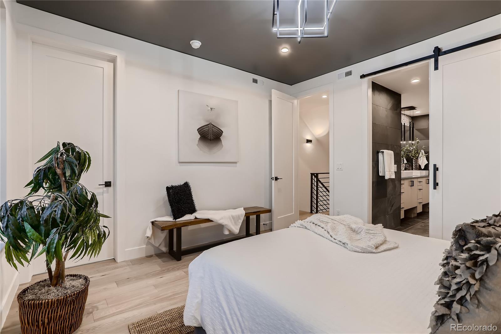 29 Harrison Street Denver, CO 80206 - Photo 13 of 40 a bedroom with bed and a potted plant