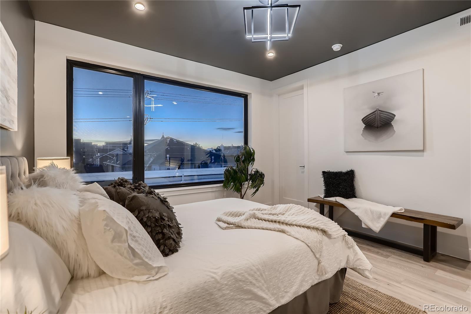 29 Harrison Street Denver, CO 80206 - Photo 14 of 40 a bedroom with a large bed and a large window