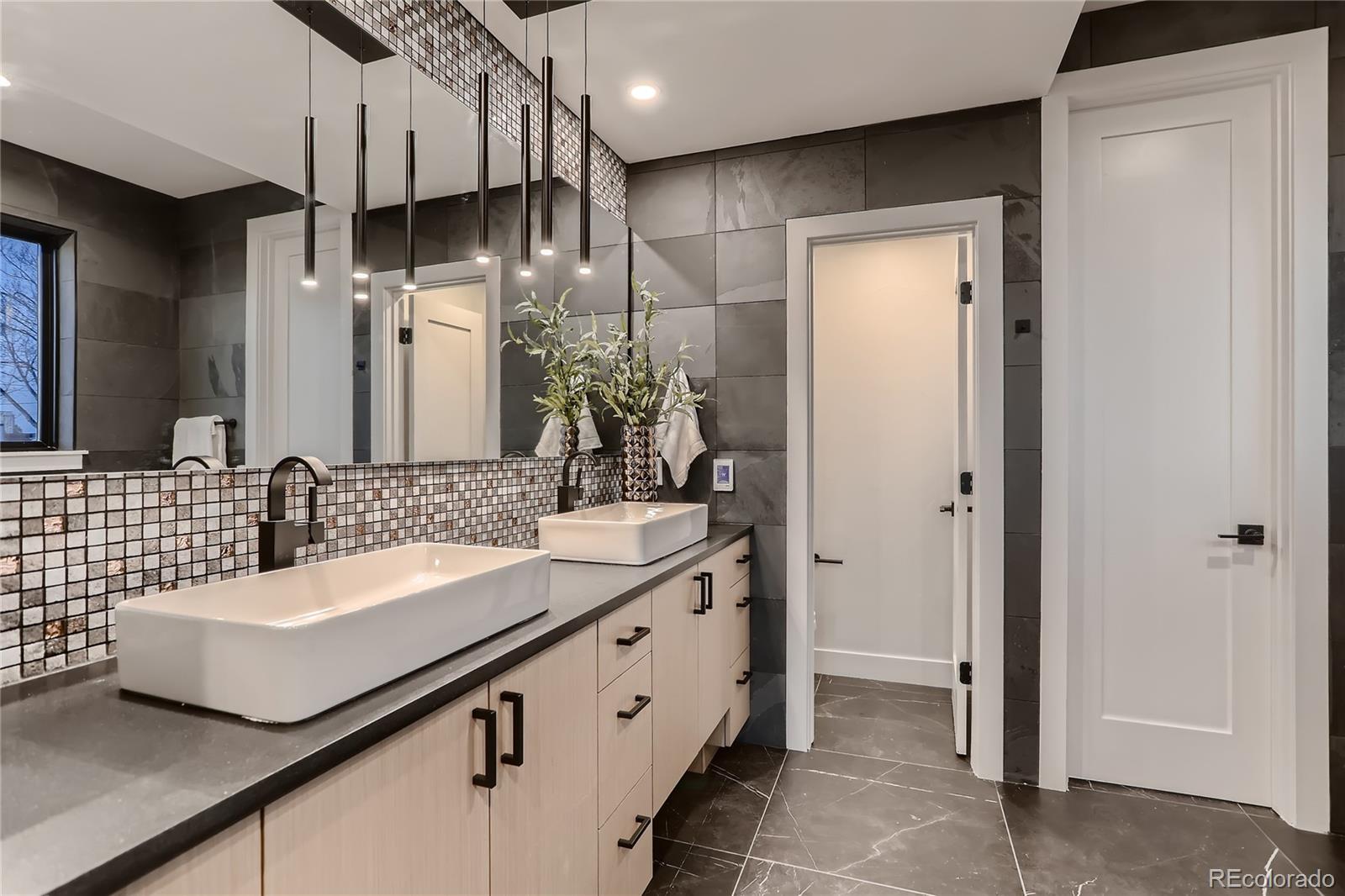29 Harrison Street Denver, CO 80206 - Photo 15 of 40 a bathroom with a double vanity sink and a mirror