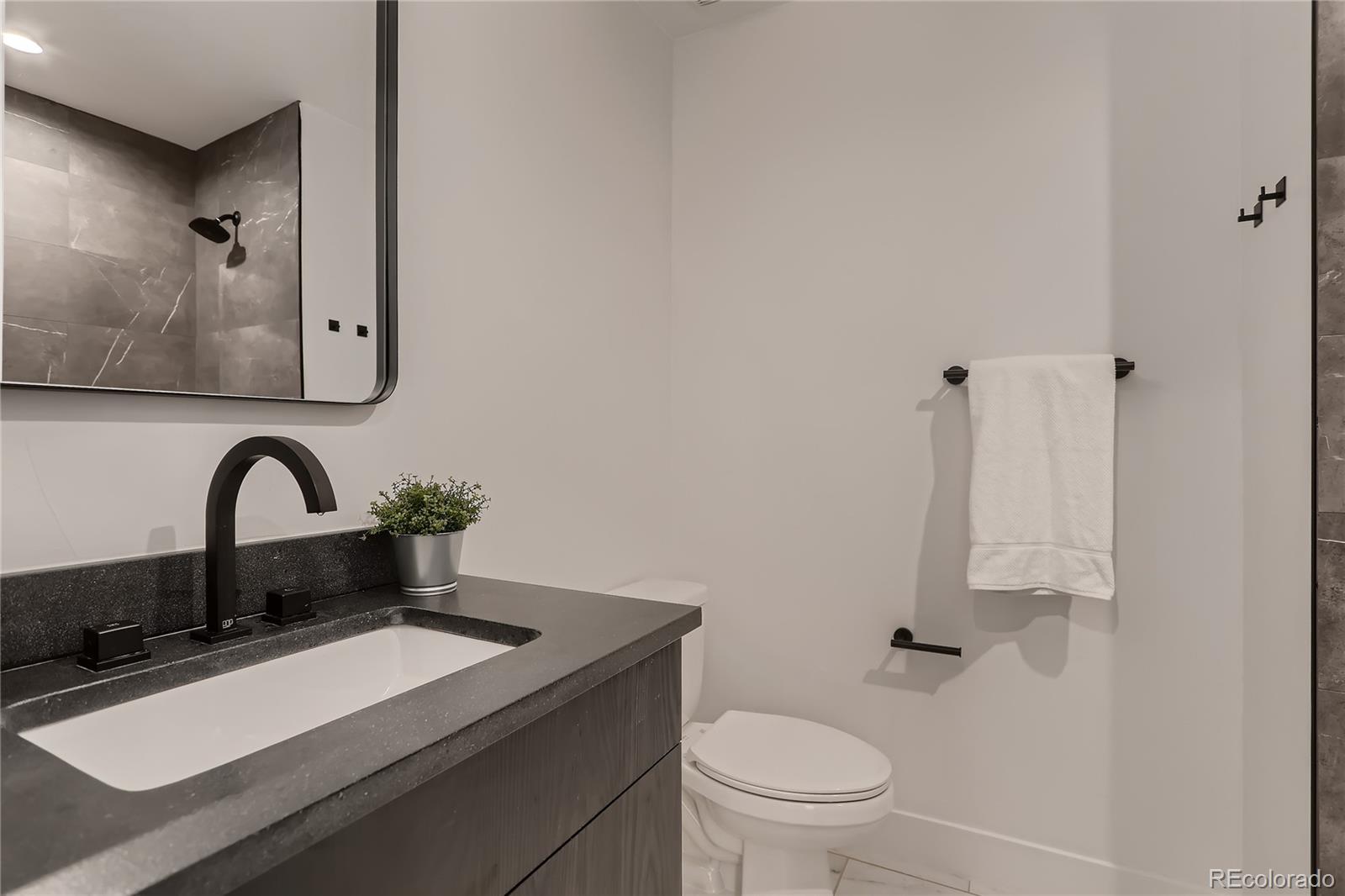 29 Harrison Street Denver, CO 80206 - Photo 19 of 40 a bathroom with a sink and a toilet