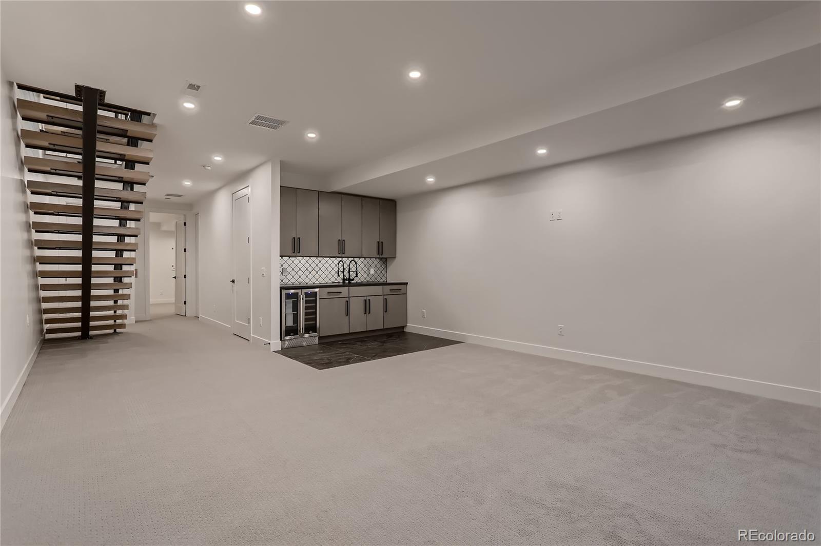 29 Harrison Street Denver, CO 80206 - Photo 25 of 40 an empty room with white cabinets and outdoor space