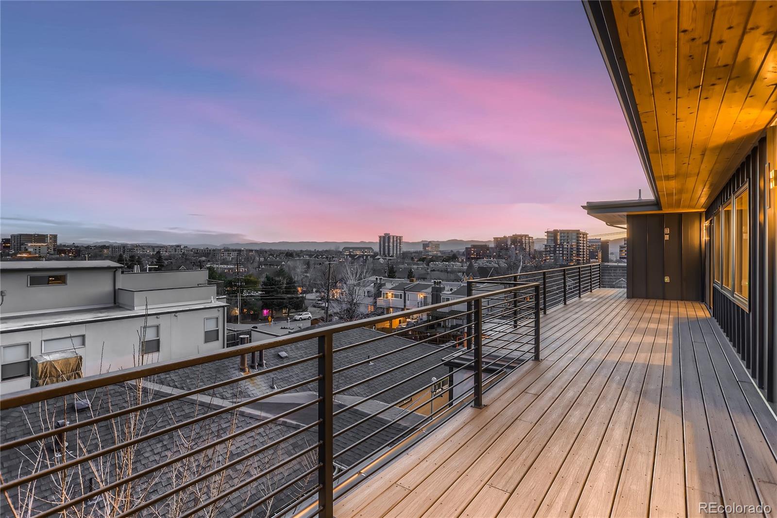 29 Harrison Street Denver, CO 80206 - Photo 32 of 40 a view of a balcony with wooden floor and city view