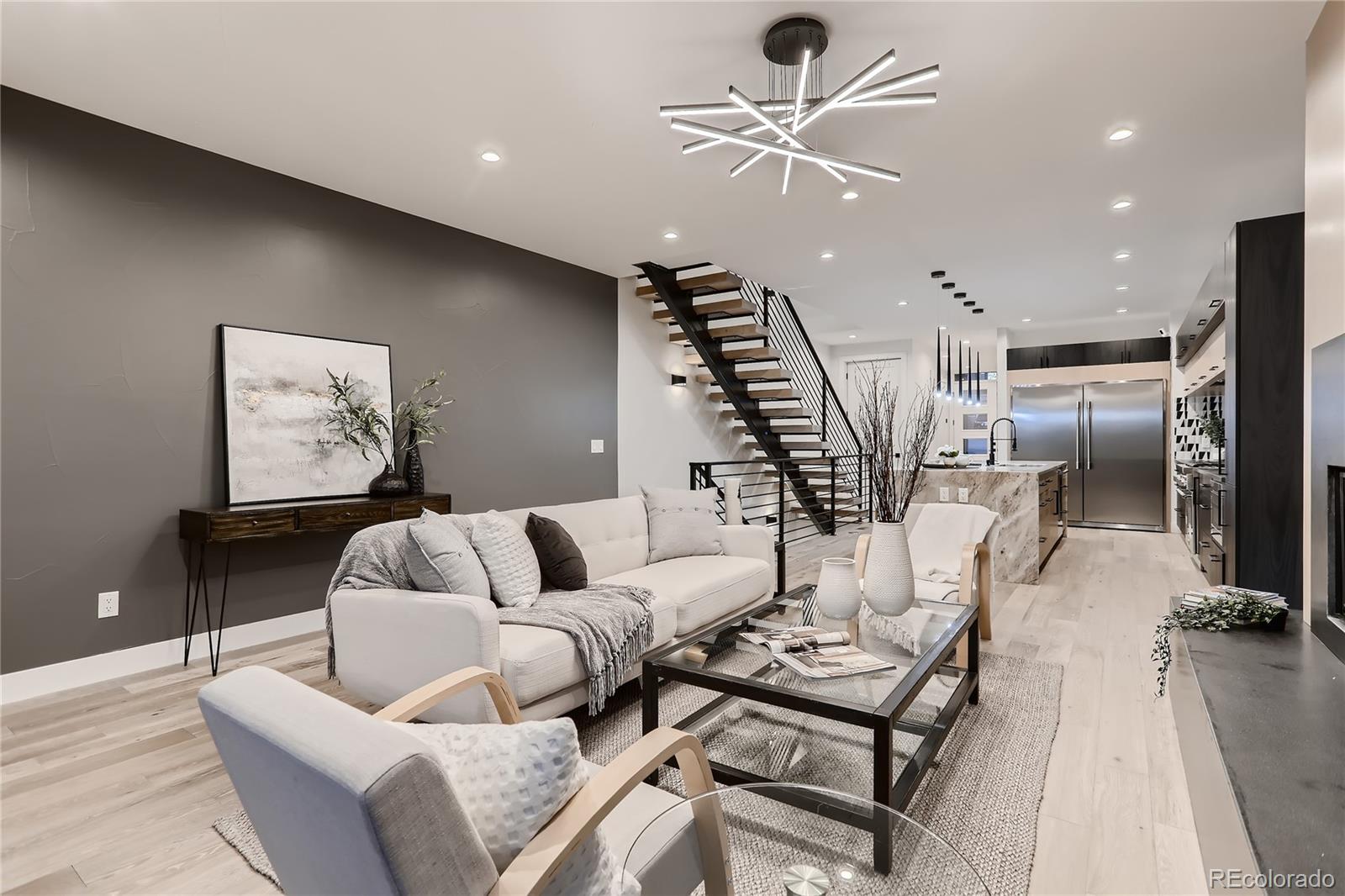 29 Harrison Street Denver, CO 80206 - Photo 4 of 40 a living room with furniture kitchen view and a chandelier