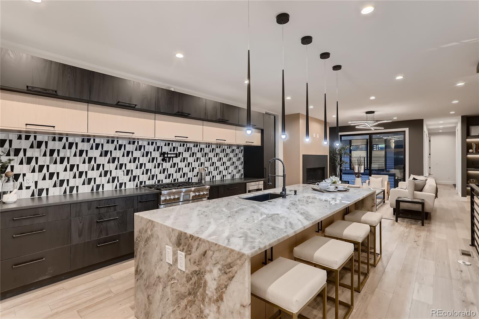 29 Harrison Street Denver, CO 80206 - Photo 6 of 40 a kitchen with a sink and chairs