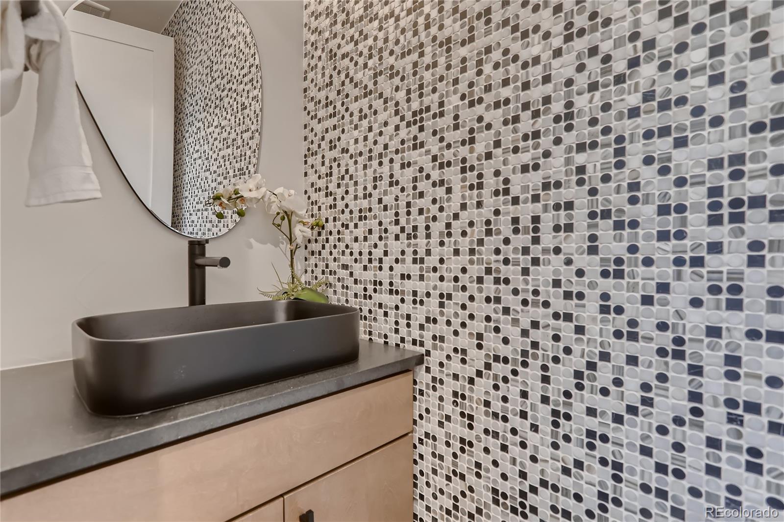 29 Harrison Street Denver, CO 80206 - Photo 9 of 40 a bathroom with a sink a vanity and a mirror