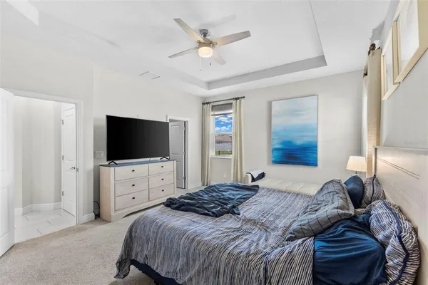 a bedroom with a bed a television and dresser