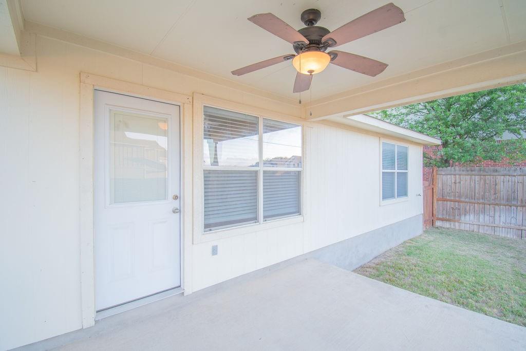 312 Pheasant Ridge Drive Round Rock, TX 78665 - Photo 31 of 34 A spacious covered patio provides a delightful outdoor living space.