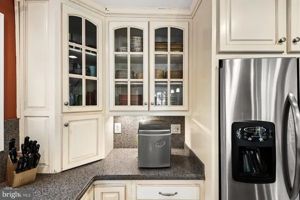 a kitchen with stainless steel appliances granite countertop a refrigerator and a stove