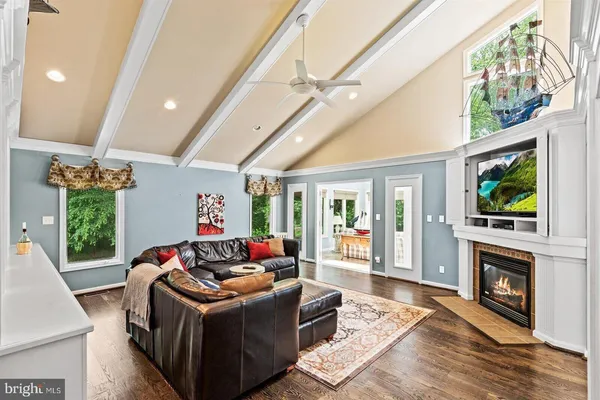 a living room with fireplace furniture and a flat screen tv