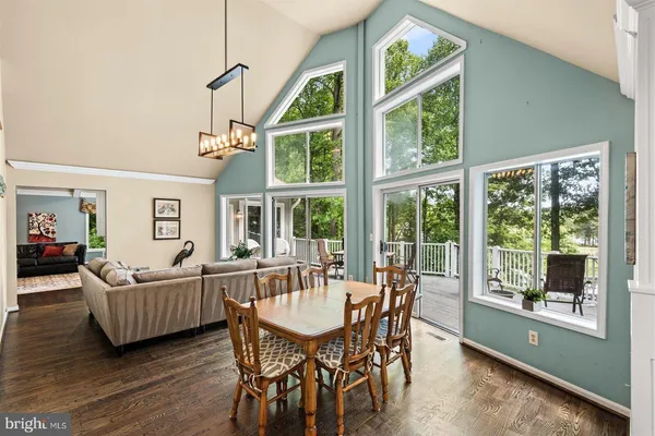 a view of a livingroom with furniture wooden floor and windows