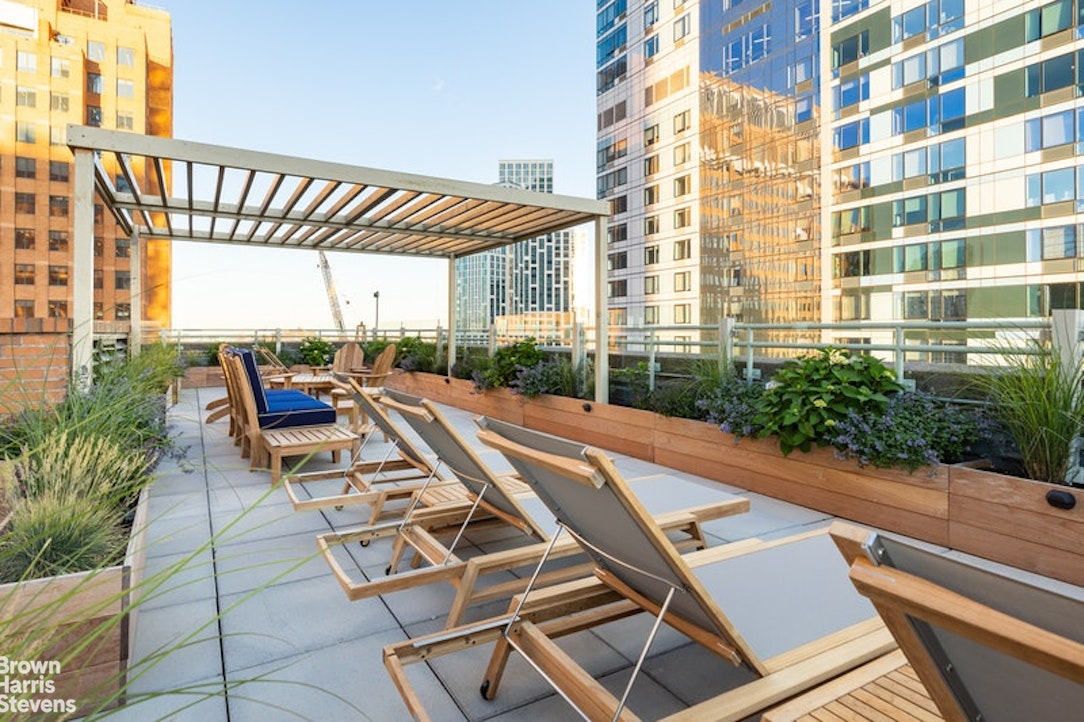 365 Bridge Street, Unit 3M Brooklyn, NY 11201 - Photo 7 of 12 a view of a patio with a table and chairs