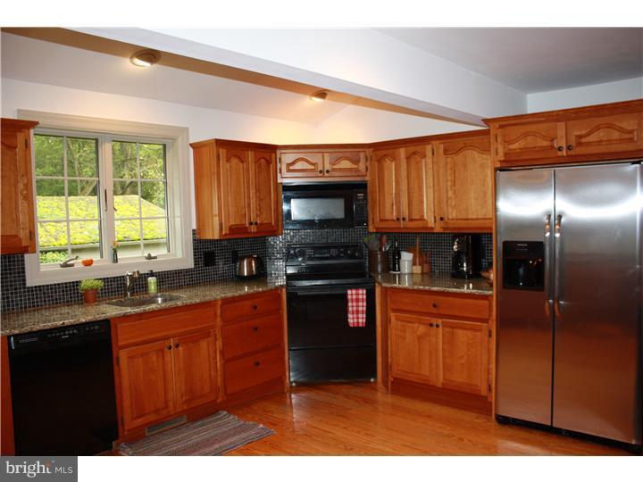 364 East Hillendale Road Kennett Square, PA 19348 - Photo 7 of 17 a kitchen with stainless steel appliances granite countertop a stove a sink dishwasher and a microwave oven with cabinets