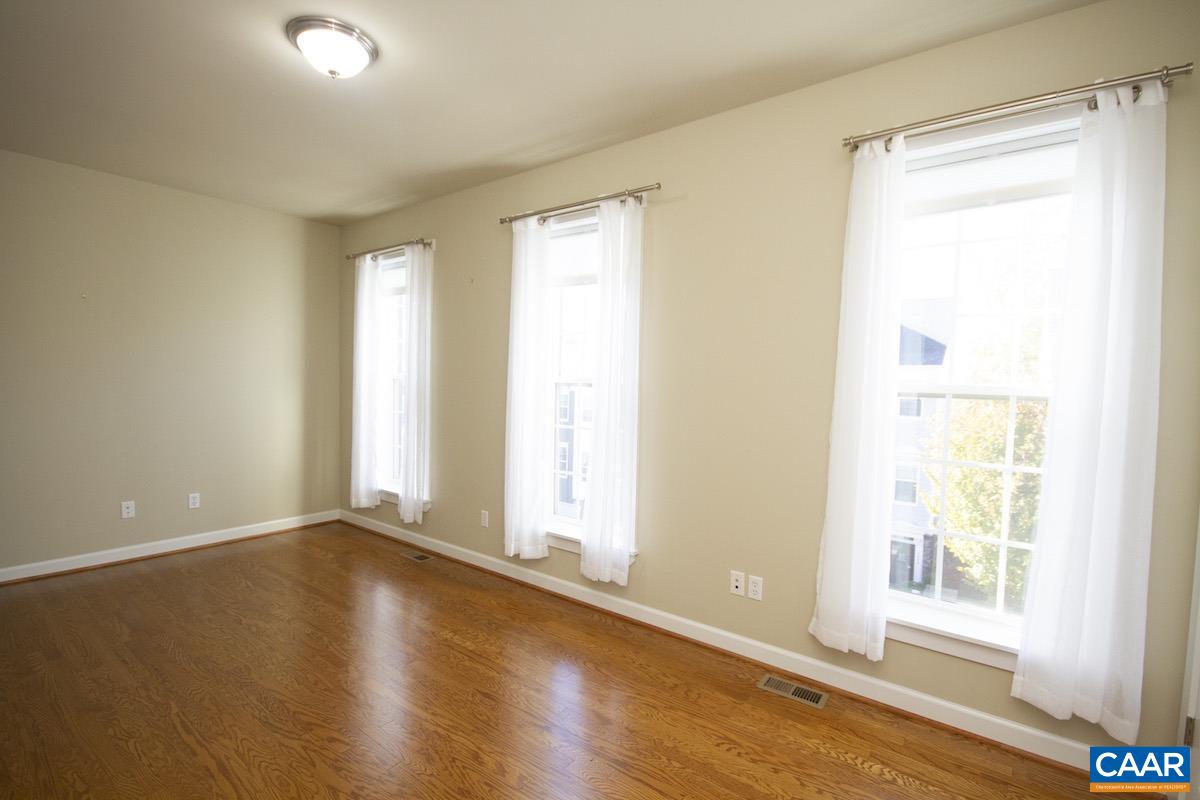 2095 Avinity Loop Charlottesville, VA 22902 - Photo 39 of 42 a view of an empty room with wooden floor and a window