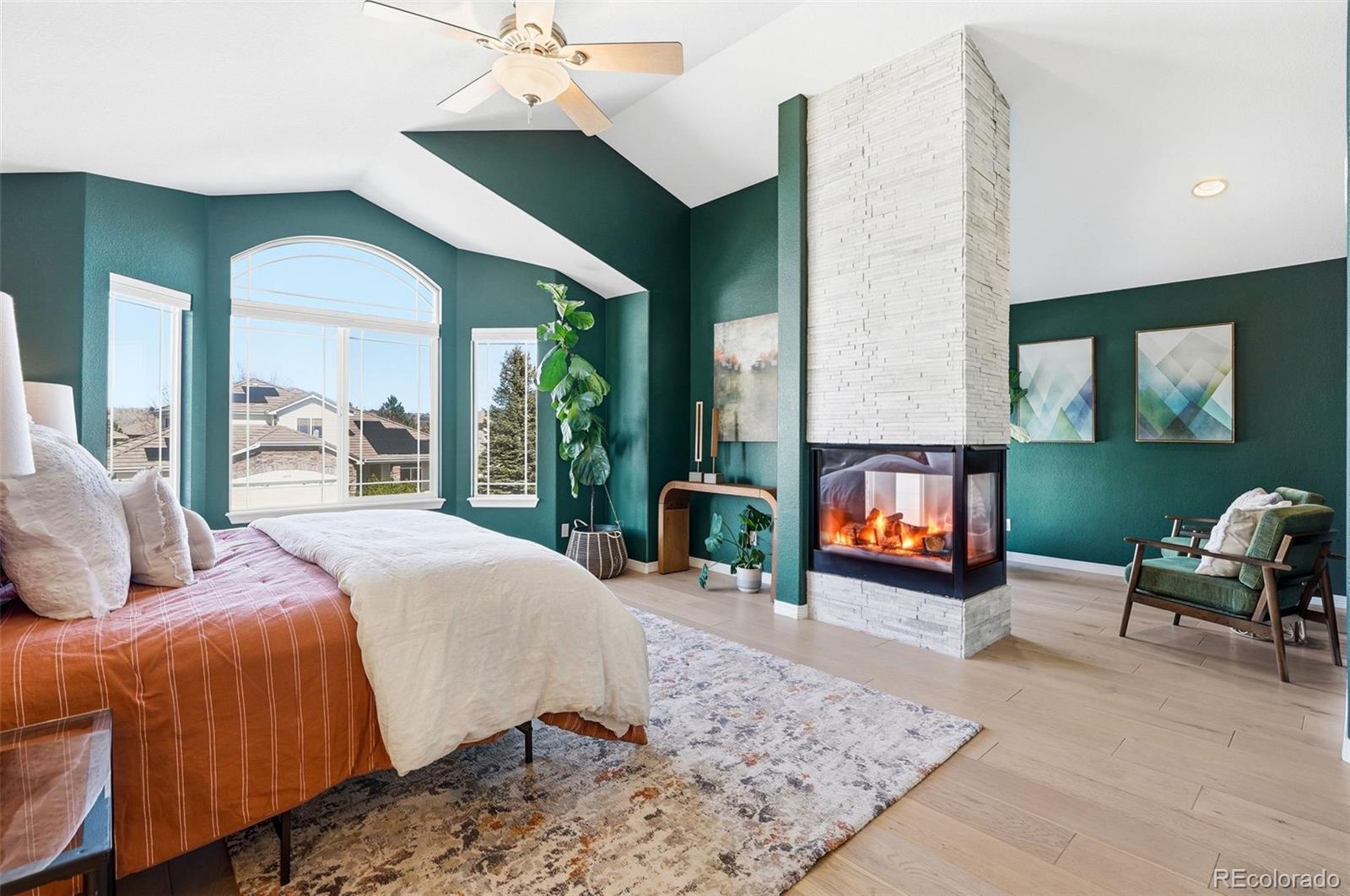 6670 Violet Way Arvada, CO 80007 - Photo 20 of 50 a bed room with a bed and a fireplace