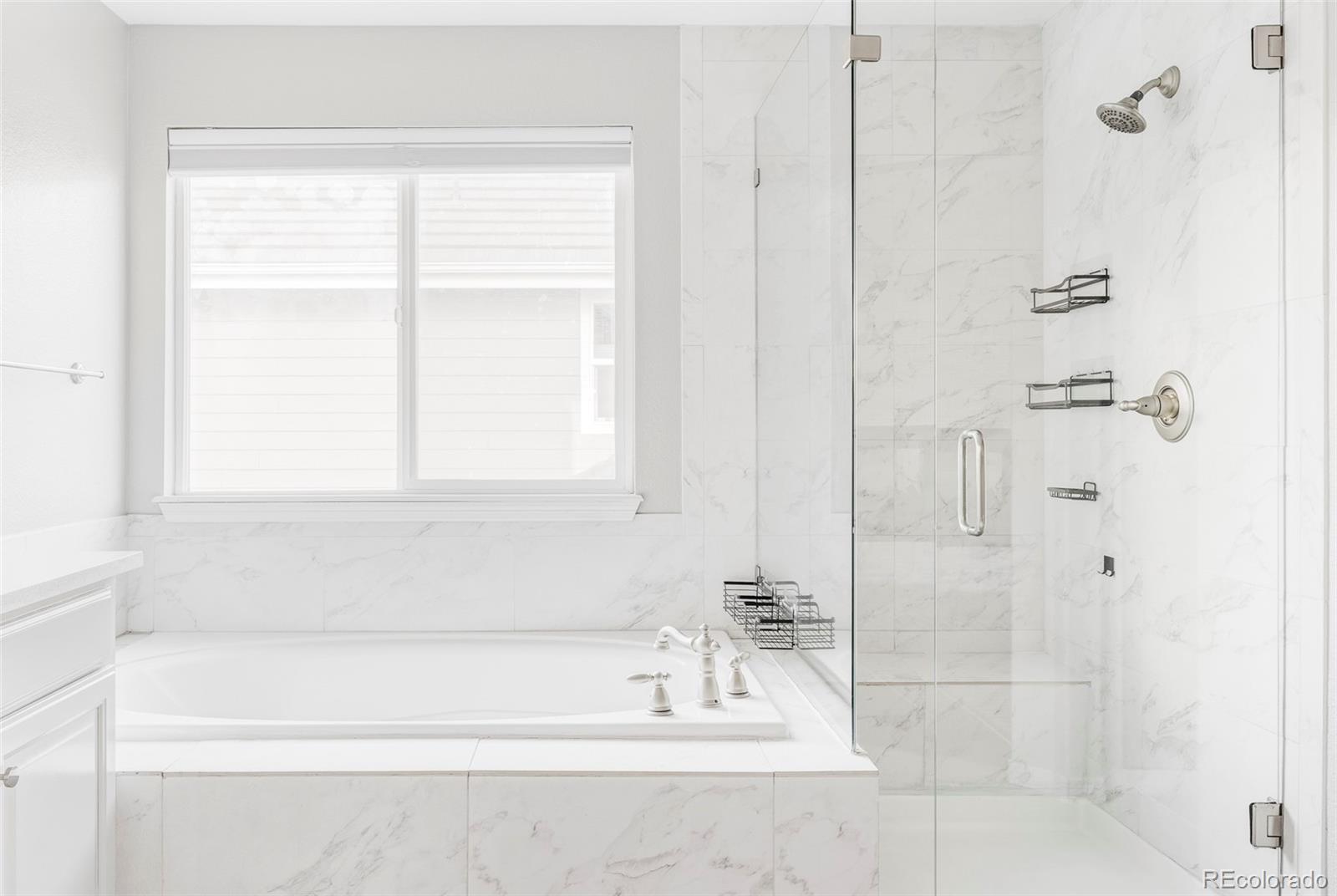 6670 Violet Way Arvada, CO 80007 - Photo 23 of 50 a bathroom with a bathtub and a shower