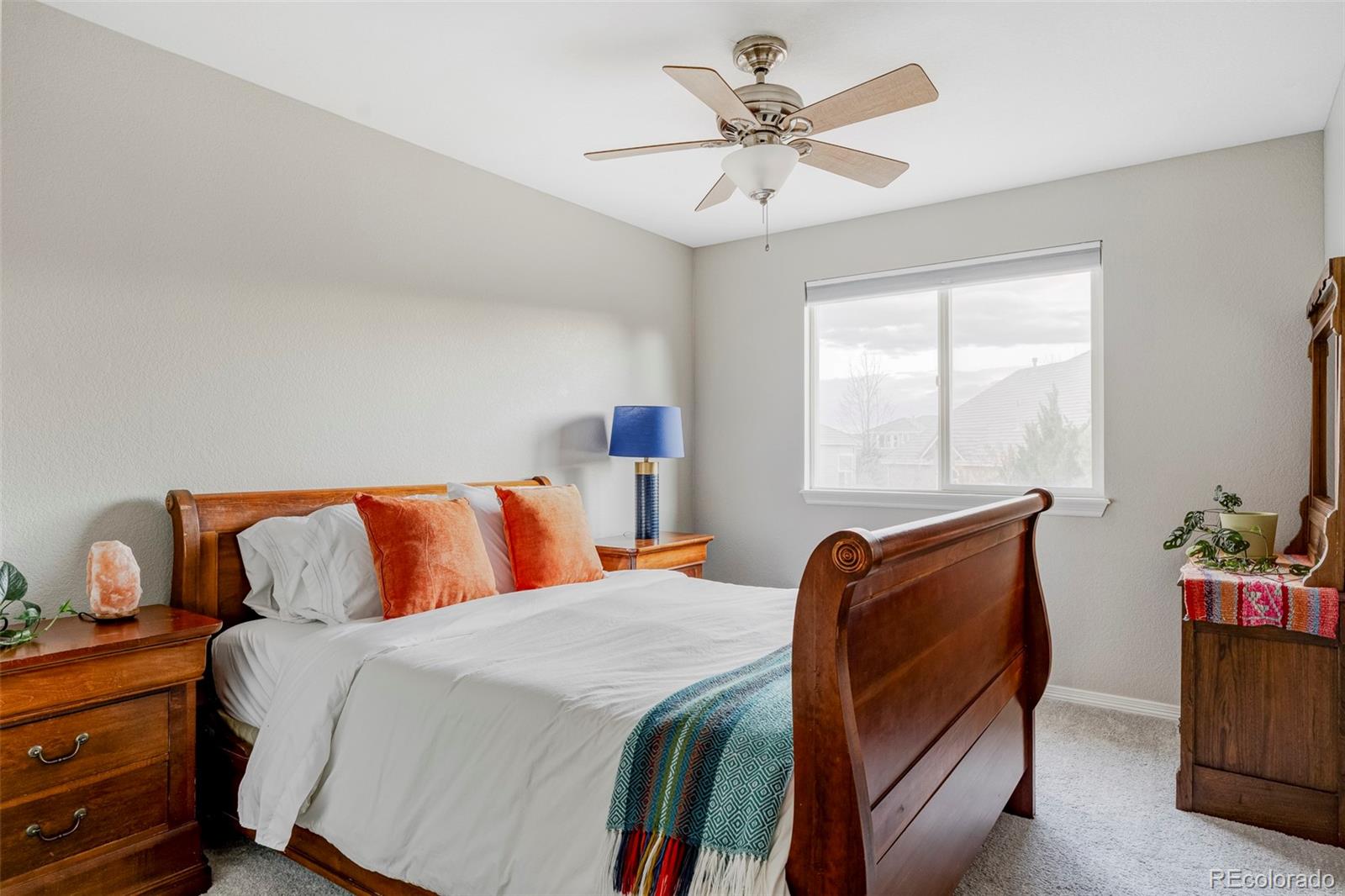 6670 Violet Way Arvada, CO 80007 - Photo 25 of 50 a bedroom with a large bed and a chandelier