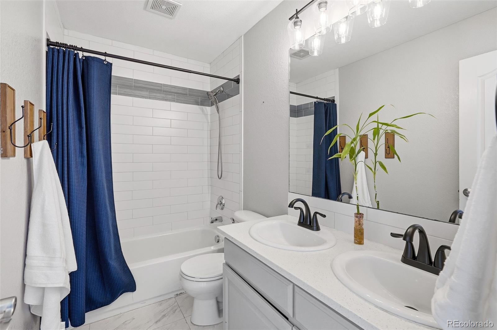 6670 Violet Way Arvada, CO 80007 - Photo 27 of 50 a bathroom with a sink a toilet and shower