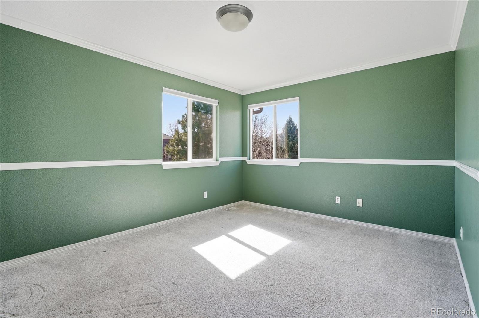 6670 Violet Way Arvada, CO 80007 - Photo 29 of 50 a bedroom with a window and a ceiling fan