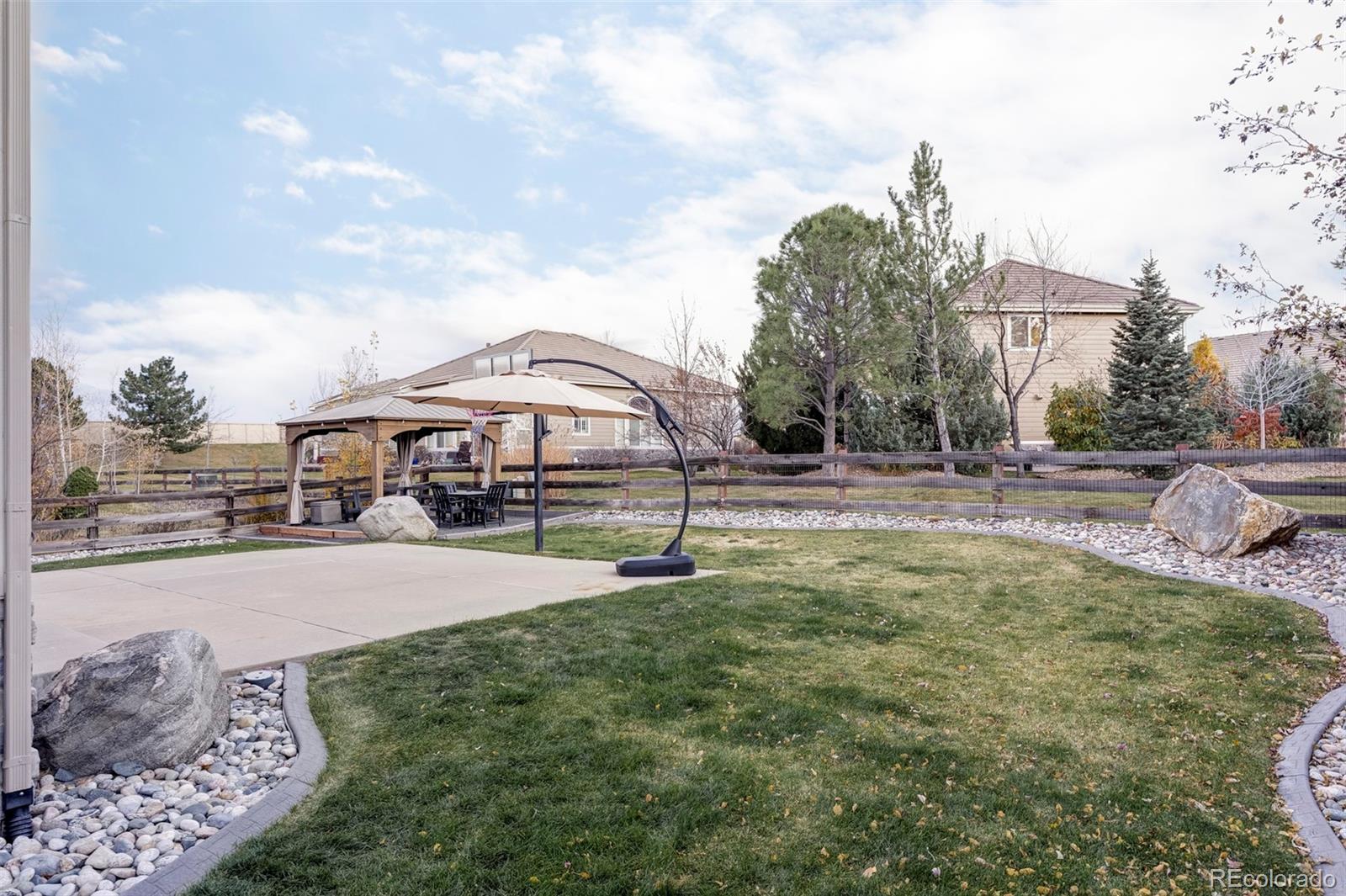 6670 Violet Way Arvada, CO 80007 - Photo 37 of 50 a swimming pool with outdoor seating and yard
