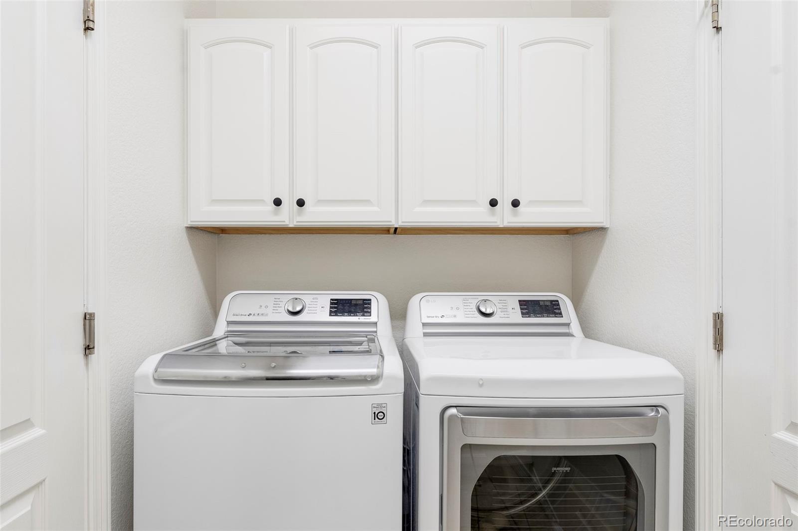 6670 Violet Way Arvada, CO 80007 - Photo 39 of 50 a view of washer and dryer with rug
