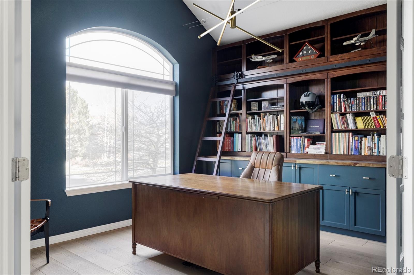 6670 Violet Way Arvada, CO 80007 - Photo 10 of 50 a room with bookshelf and a window
