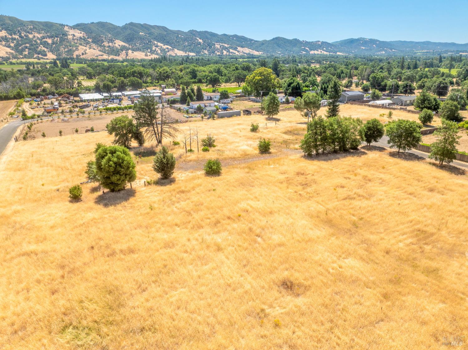 10891 West Road Redwood Valley, CA 95470 - Photo 7 of 28 a view of a lake with mountains in the background