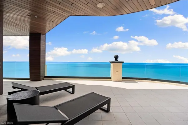 a view of a terrace with a table and chairs