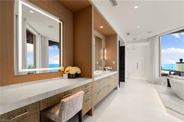 a spacious bathroom with double vanity and a large mirror